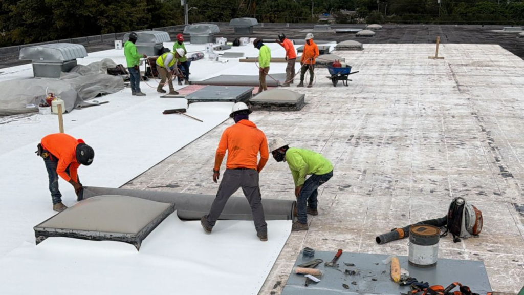 Roofing contractor inspecting an older residential roof for damage