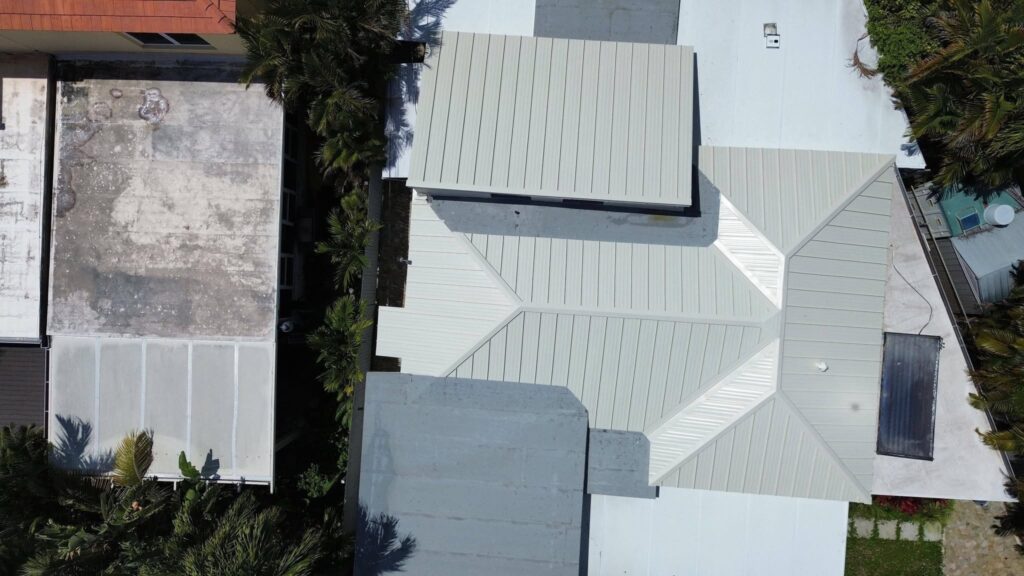 High-quality roof installation Florida showing roofing contractor installing shingles on Florida home