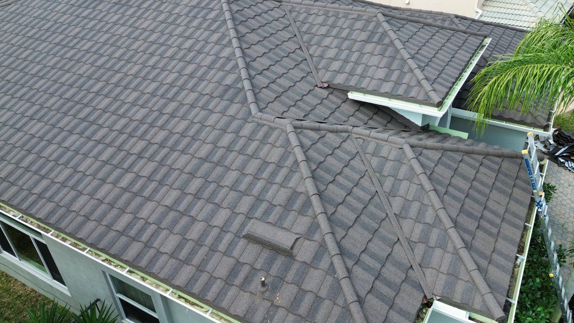 Storm damage roof repair Florida by a roofing contractor inspecting storm-damaged shingles